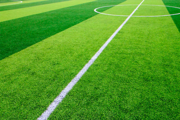 istock The white Line marking on the artificial green grass soccer field 821386628