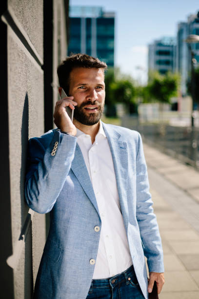 istock Handsome man talking on his mobile phone outdoors 821398918