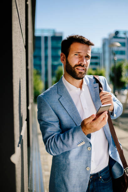 istock Young businessman using smartphone outdoors 821401806