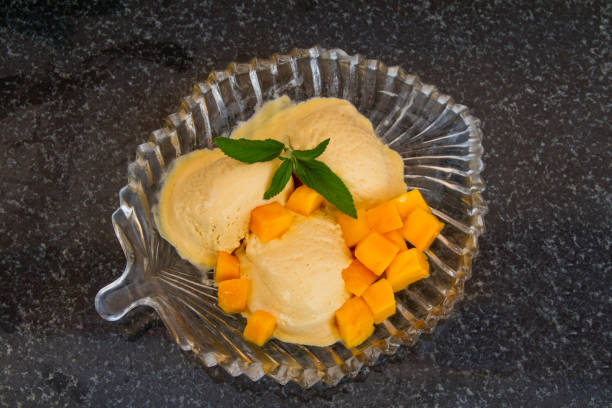 istock Fruit ice cream with fresh fruit slices with leaves mint on a glass plate. 821410050