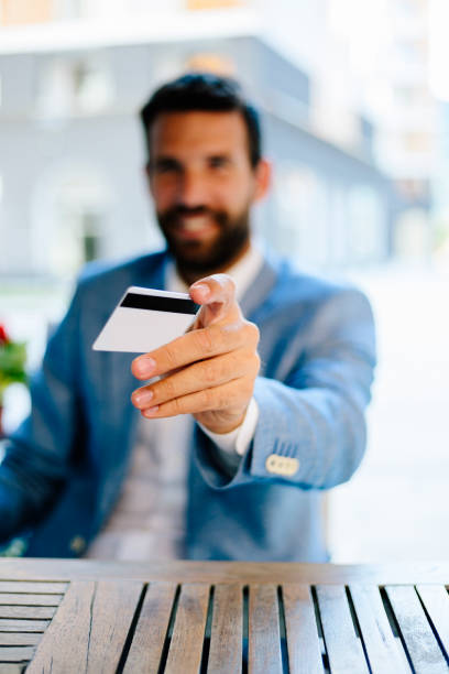 istock Close up of man using credit card for paying 821410246