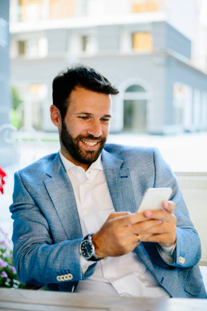 istock Handsome businessman in cafe bar typing message 821410384