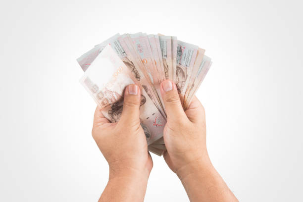 istock The Thailand money in hand ,isolate . 821411114