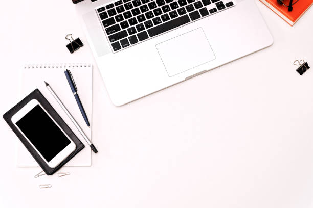 istock Workspace with laptop keyboard mobile phone coffee glasses 821416148