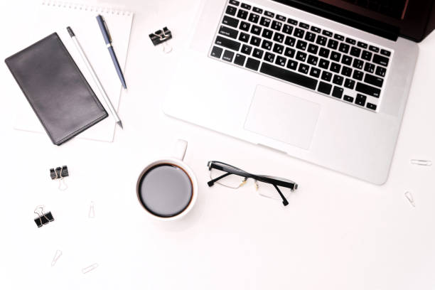 istock Workspace with laptop keyboard coffee glasses diary and flowers 821416162