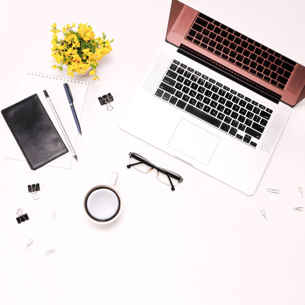 istock Workspace laptop keyboard mobile phone coffee glasses and flowers 821416164