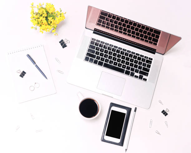 istock Workspace laptop keyboard mobile phone glasses coffee and flowers 821416176