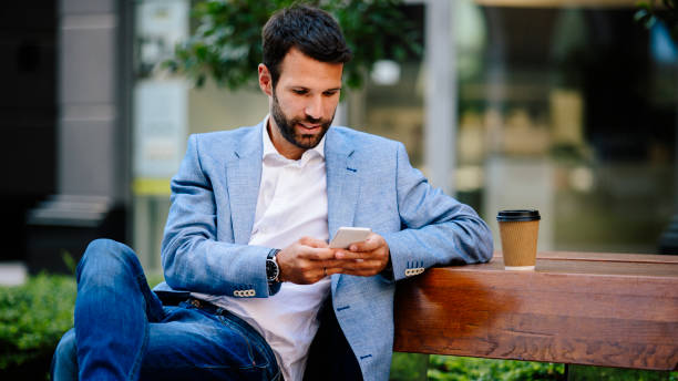 istock Young man typing message outdoors 821416744