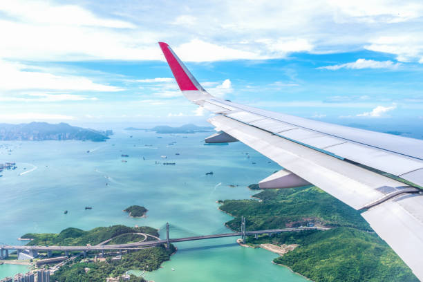 istock View of airplane wing.Flying high above the blue sky. 821416780