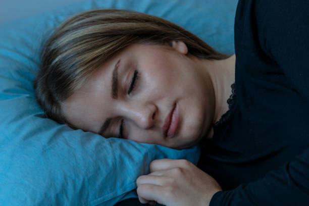 istock Beautiful young brunette woman sleeping in a white bed. 821422346