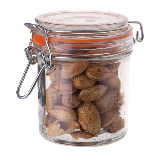 istock Bottle of Almond nut in shell isolated on white background 821425830