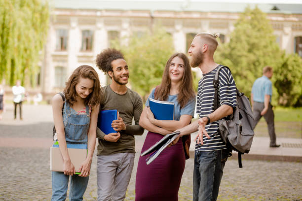 istock College friends standing, laughing in campus. 821426890