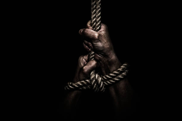 istock woman hands bound prisoner in room 821429194