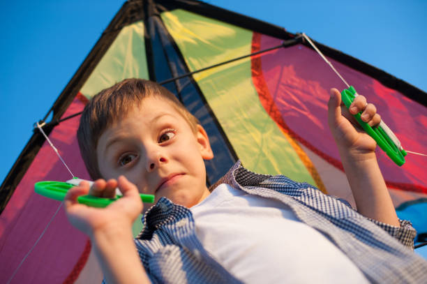 istock Surprised funny small boy with a kite on his shoulders 821433676