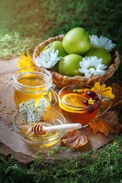 istock Fresh honey, pollen and ripe apples on a wooden table. Selective focus 821434344