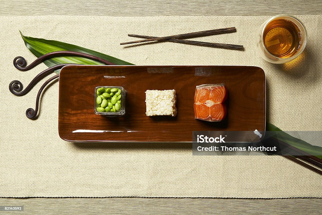 food on plate with bevarage uncooked salmon cooked brown rice cooked soybeans tea Brown Rice Stock Photo