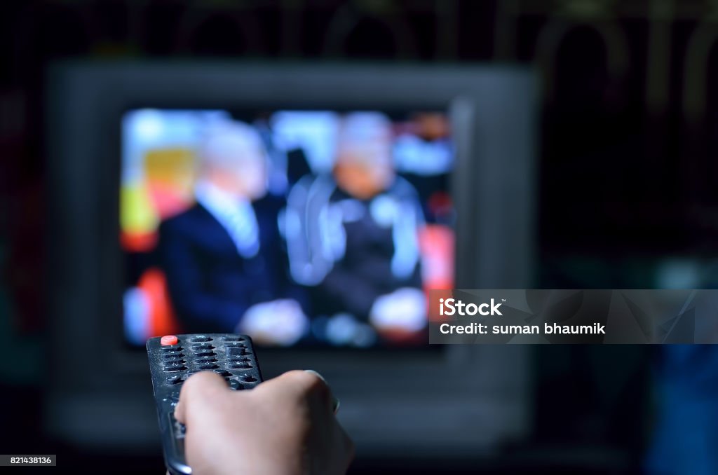 Changing chanels Changing chanels by tv remote Television Industry Stock Photo