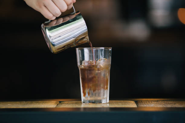 istock Barista pouring coffee for iced americana 821442132