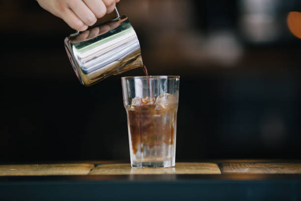 istock Barista pouring coffee for iced americana 821442186
