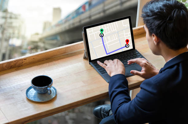 Businessman sitting and using computer laptop showing part of navigator map for choosing the direction on traffic jam background, Business transportation concept