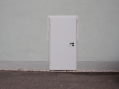 Isolated Single White Painted Modern Steel Door on Concrete Wall
