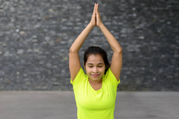 istock Young woman relaxing while practising yoga 821450864