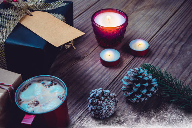 istock Christmas present gift boxes and rustic decoration with candle, hot chocolate 821458066