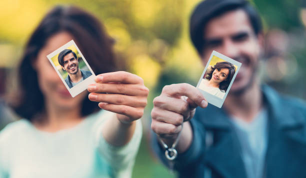 istock Happy couple showing instant self portraits 821463126