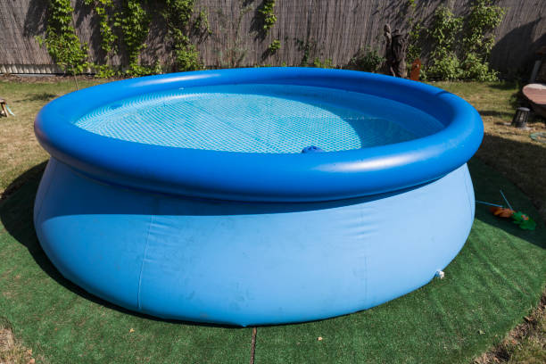 istock Blue rubber pool on the grass for children. 821471382