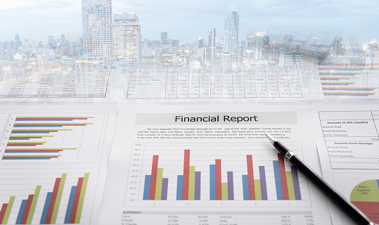 Business and financial report with business city background. Concept of accounting, financial analysis.