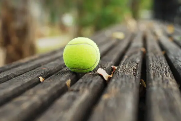 Tennis ball on wood floor