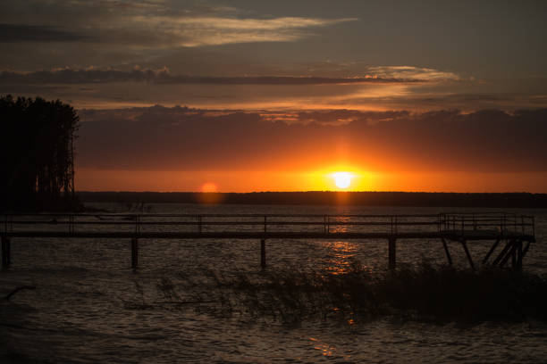 istock Wooden pier at sunset 821475238