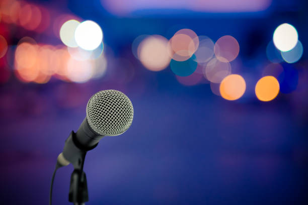 istock Close up microphone on stage in concert hall. 821482814