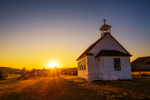 Summer sunset over the old wooden pioneer church in the ghost town of Dorothy in Alberta, Canada.