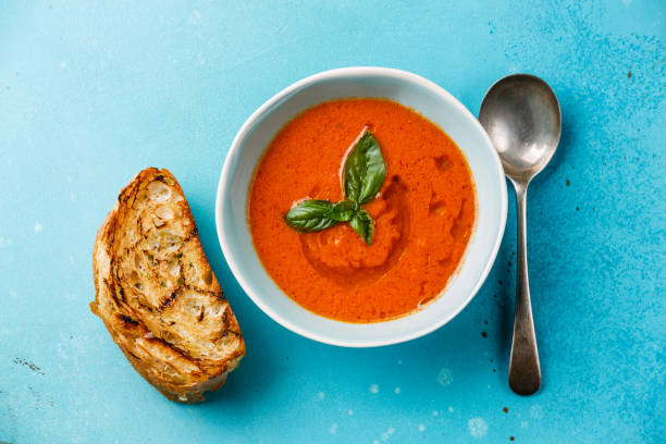istock Gazpacho soup and bread on blue 821485674