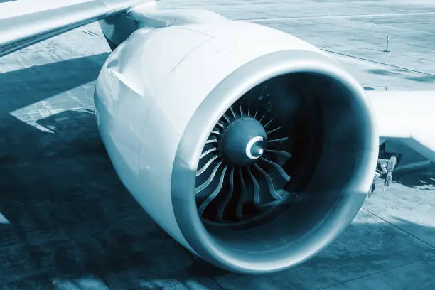 Huge engine of the Boeing 777-300ER, detailed view of the appearance of the turbine blades of an aircraft engine, technical color blue