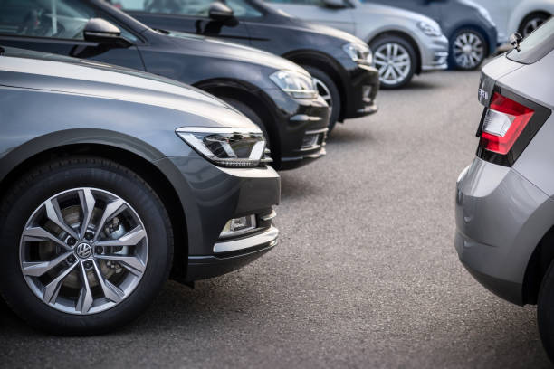 a row of modern vehicles standing on a public parking space in hamburg, germany - golf imagens e fotografias de stock
