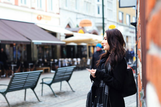istock Woman waiting outsidewith smartphone 821494206