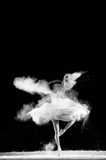 istock Beautiful ballet dancer, dancing with powder on stage 821494634