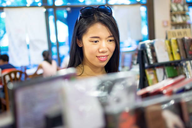 istock Asian girl buying a compact disc 821497550