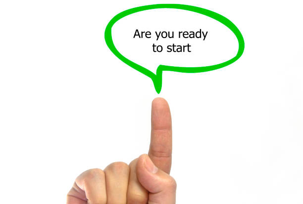 istock Hand writing are you ready to start with green talking bubble, isolated on white background 821497612