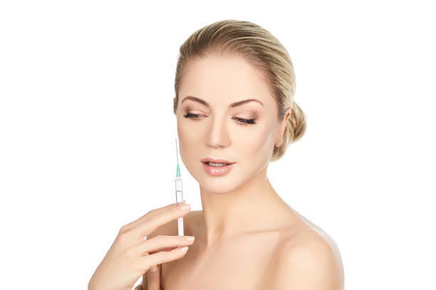 istock beautiful girl holding syringe isolated on white 821501260