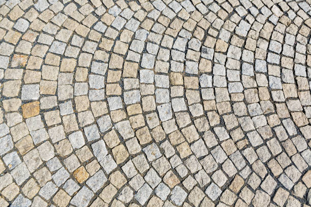 istock The stone pavement as the background texture, Stone block road pavement 821505754
