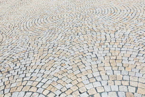 istock The stone pavement as the background texture, Stone block road pavement 821505792