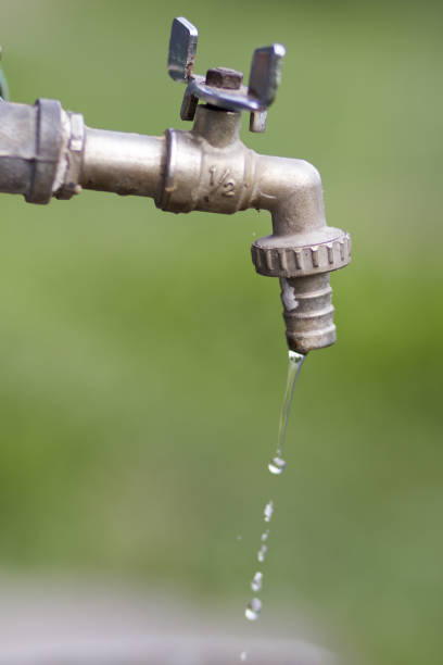 istock Old water tap on green blur background 821513144
