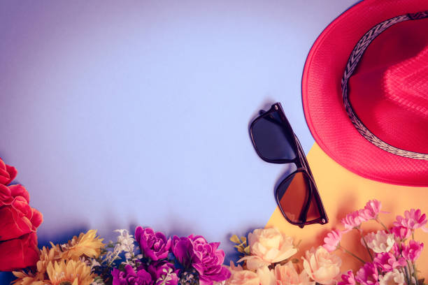 istock Flat lay hat and sunglasses with flowers on top table 821513370