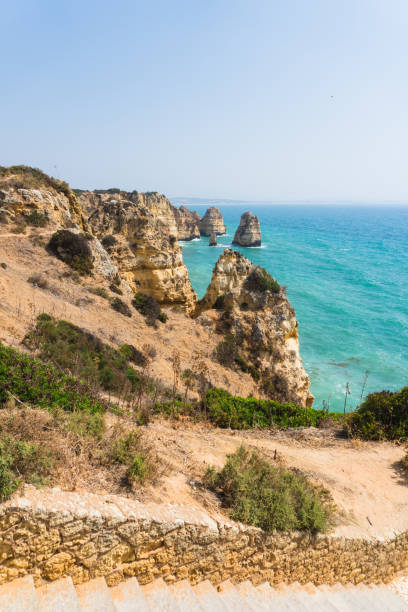 istock Spending summer holidays in seascape view on rocks cliffs with seas caves on sandy beach. Summer time 821520990