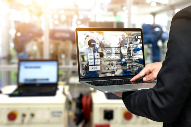 istock Engineer hand using laptop with machine real time monitoring system software. Blur automation robot arm machine in smart factory Industry 4th iot , digital manufacturing operation technology concept. 821521092