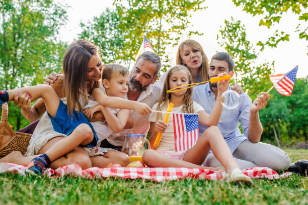 istock Happy big family playing soap bubbles in park 821521118