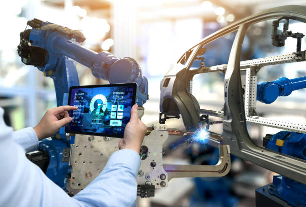 Engineer hand using tablet with machine real time monitoring system software. Automation robot arm machine in smart factory automotive industrial Industry 4th iot , digital manufacturing operation. Engineer hand using tablet with machine real time monitoring system software. Automation robot arm machine in smart factory automotive industrial Industry 4th iot , digital manufacturing operation. automobile industry stock pictures, royalty-free photos & images